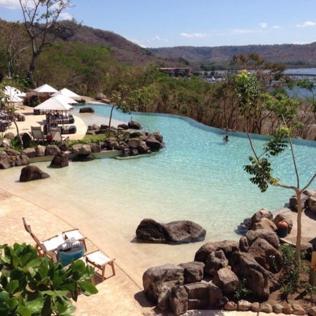 Beach like infinity pool - Master Pools Guild