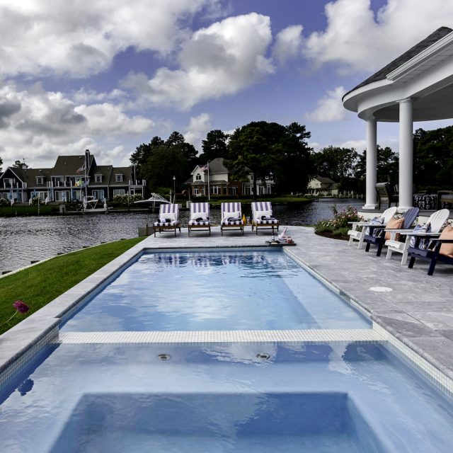 Traditional swimming pool by lake - Master Pools Guild