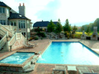 Traditional swimming pool with water feature - Master Pools Guild