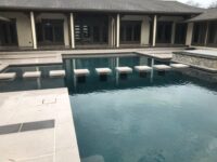 Residential traditional pool with water feature - Master Pools Guild